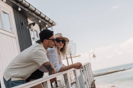 Photo for Young romantic couple spending hot summer day on sea view terrace together - Royalty Free Image