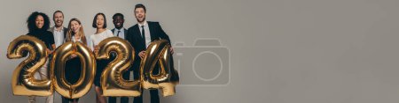 Photo for Happy business team in formalwear holding 2024 numbers while celebrating New Year on studio background - Royalty Free Image