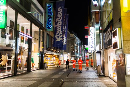 Photo for Cologne, Germany - February 25, 2015: Hohe Strasse Cologne's popular location and famous shopping street is cleaned by sanitation workers at night. - Royalty Free Image