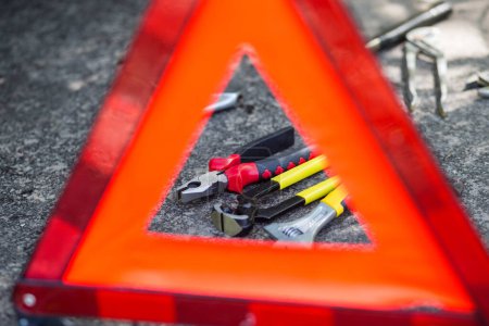 Photo for Red emergency stop sign and many mechanical tools used for fixing car problems - Royalty Free Image