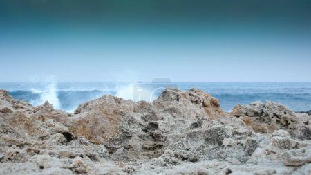 Foto de Rocky cliff in the sea, the waves crashing into the sea, Protaras, Cyprus. - Imagen libre de derechos