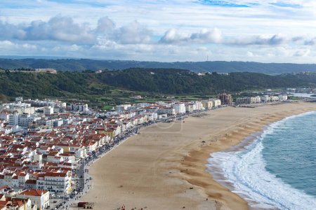 Photo for The city of Nazare in Portugal, the symbol of surfing. Coastline and view from above on the town. Tourist place with big waves. Landscape photo. - Royalty Free Image