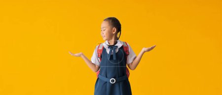 Téléchargez les photos : Back to school banner idea concept, Asian student little girl hands holding on copy space, isolated on yellow background with Clipping paths for design work empty - en image libre de droit