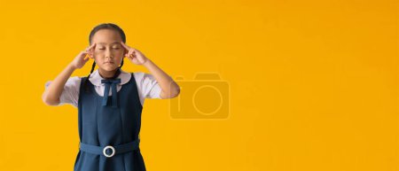 Photo for Back to school banner idea concept, Asian student cute little girl wears school uniform Close your eyes and think creative positive, isolated on yellow background with Clipping paths - Royalty Free Image