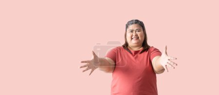 Photo for Asian fat woman, Fat girl , Chubby, showing hand blank area for sign, isolated on pink background. Clipping paths for design work empty free space - Royalty Free Image