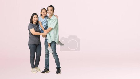Photo for Happy asian family of father, mother and daughter hug, isolated on pink background with Clipping paths for design work empty free space - Royalty Free Image