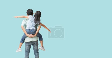 Foto de Happy asian family of father and daughter hug spread out your arms, Back view isolated on blue background with Clipping paths for design work empty free space - Imagen libre de derechos