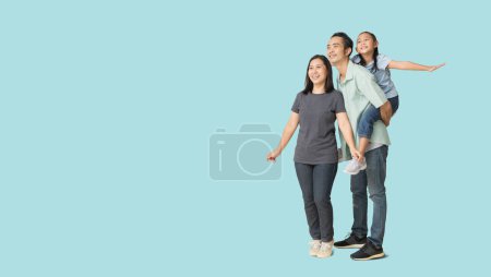 Téléchargez les photos : Happy asian family of father, mother and daughter hug spread out your arms, isolated on blue background with Clipping paths for design work empty free space - en image libre de droit