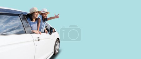 Foto de Happy asian woman and child in car summer vacation concept, isolated on blue background with Clipping paths for design work empty free space - Imagen libre de derechos
