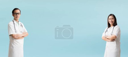 Photo for Medical Services. Asian doctor woman and man, Happy and Smiling Posing arms crossed blank workspace, isolated on blue background - Royalty Free Image