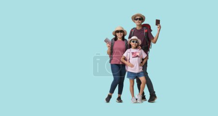 Photo for Family Travel Concept, Full body Happy asian family vacation, Father, mother and little daughter, Hand Holding passports and tickets ready for vacation trip, isolated on pastel plain light blue - Royalty Free Image