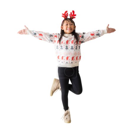 Foto de Alegre joven asiática chica usando un suéter de Navidad con cuernos de reno, feliz sonrisa extendió sus brazos de pie posando retrato de cuerpo completo, aislado sobre fondo blanco, recorte de caminos - Imagen libre de derechos