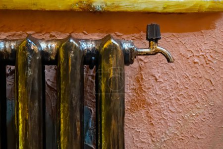 Photo for Old fashioned steam or hot water heating bronze painted cast iron radiator - Royalty Free Image