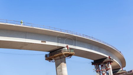Photo for New Road Highway junction inter section entry exit ramp elevated  concrete moulded structure with distant civil engineer closeup section upward photograph . - Royalty Free Image