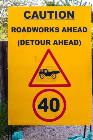 Photo for Road Caution warning sign words Roadworks Detour Ahead. Close-Up Yellow and Black detail. - Royalty Free Image