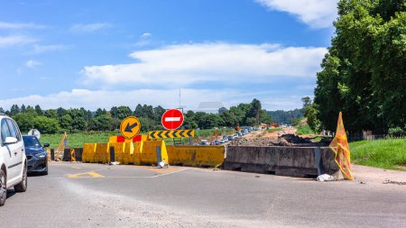 Photo for Vehicles traffic jam road caution warning sign roadworks expansion contruction detour ahead. close-up yellow barriers - Royalty Free Image