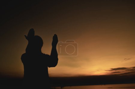 Photo for Silhouette Young asian muslim man praying on sunset,Ramadan festival concept - Royalty Free Image