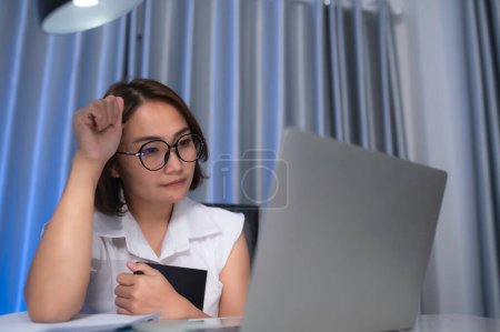 Photo for Beautiful asian woman working at home on the night,A lot of work from company,bring home work,Work from home - Royalty Free Image