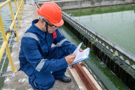 Photo pour Water plant maintenance technicians, mechanical engineers check the control system at the water treatment plant. - image libre de droit