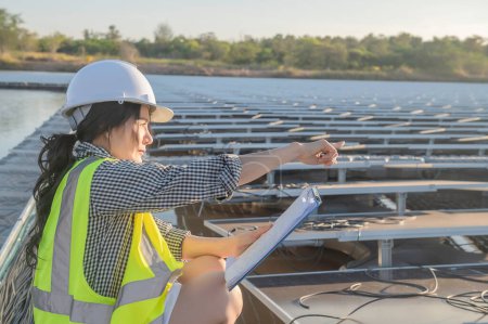 Photo for Asian engineer working at Floating solar farm,Renewable energy,Technician and investor solar panels checking the panels at solar energy installation - Royalty Free Image