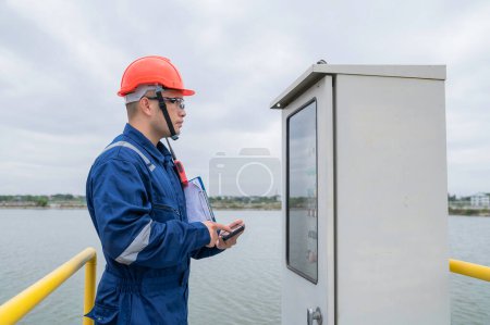 Photo for Water plant maintenance technicians, mechanical engineers check the control system at the water treatment plant. - Royalty Free Image