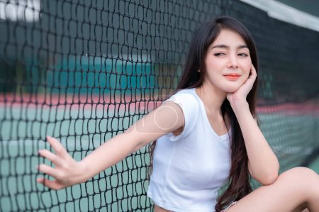 Photo for Hipster asian girl pose for take a photo,Fashion portrait pretty woman at tennis court,lifestyle of modern teenage thai girl - Royalty Free Image