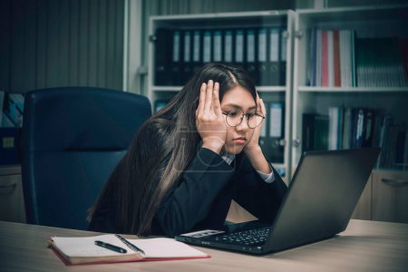 Photo for Asian woman working in office,young business woman stressed from work overload with a lot file on the desk,Thailand people thinking something - Royalty Free Image
