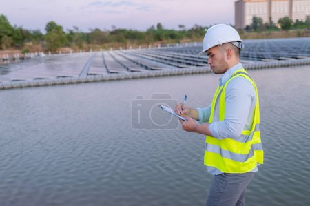 Foto de Ingeniero asiático que trabaja en Floating solar farm, Renewable energy, Technician and investor solar panels checking the panels at solar energy installation - Imagen libre de derechos