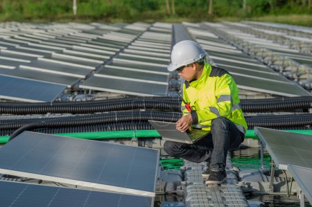 Photo for Asian engineer working at Floating solar power plant,Renewable energy,Technician and investor solar panels checking the panels at solar energy installation - Royalty Free Image