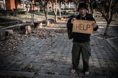 Photo for Asian man is homeless at the side road,A stranger has to live on the road alone because he has no family. - Royalty Free Image