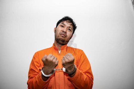Photo for Prisoner in orange robe concept,Portrait of asian handsome man in Prison uniforms,Bandit has a lot of muscle, - Royalty Free Image