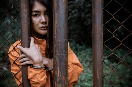 Photo for Portrait of women desperate to catch the iron prison,prisoner concept,thailand people,Hope to be free,If the violate the law would be arrested and jailed. - Royalty Free Image