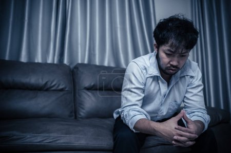 Foto de Asian handsome man stress from work overload,Tired male come back home after a lot of work from company,risk of depression - Imagen libre de derechos