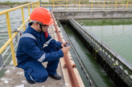 Foto de Water plant maintenance technicians, mechanical engineers check the control system at the water treatment plant. - Imagen libre de derechos