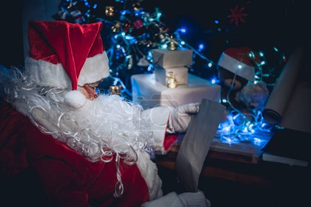 Photo for Portrait of Happy santa clause reading a book,Thailand people wear santa claus dress,Sent happiness for children,Merry christmas,Welcome to winter - Royalty Free Image