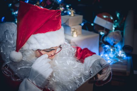 Photo for Portrait of Happy santa clause reading a book,Thailand people wear santa claus dress,Sent happiness for children,Merry christmas,Welcome to winter - Royalty Free Image
