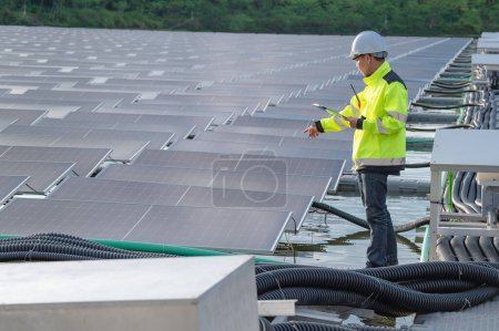 Photo for Asian engineer working at Floating solar power plant,Renewable energy,Technician and investor solar panels checking the panels at solar energy installation - Royalty Free Image