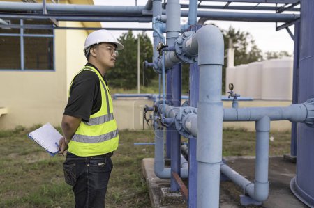 Foto de Environmental engineers work at wastewater treatment plants,Male plumber technician working at water supply - Imagen libre de derechos