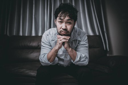 Foto de Asian handsome man stress from work overload,Tired male come back home after a lot of work from company,risk of depression - Imagen libre de derechos