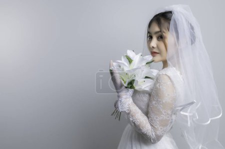 Foto de Portrait of asian woman wear bride with flower on white background,Wedding concept - Imagen libre de derechos