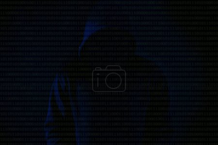Photo for Asian hacker in black hood on black background,Hack password,hacking safety systems to steal information - Royalty Free Image