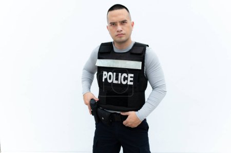 Téléchargez les photos : Portrait of police hold gun in hand on white background,Handsome asian cop - en image libre de droit