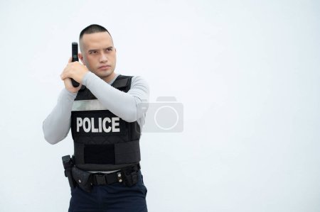 Foto de Portrait of police hold gun in hand on white background,Handsome asian cop - Imagen libre de derechos