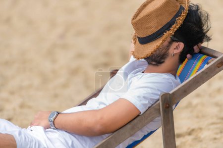 Photo for Asian man sitting chair beach inside sea,Relax time at summer - Royalty Free Image