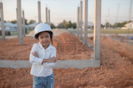 Photo for Engineer kid concept,Asian little girl wear engineer uniform working at site of building - Royalty Free Image