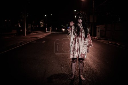 Photo for Horror woman concept,Ghost on the road in the city,A vengeful spirit on the street of the town,Halloween festival,Make up ghost face - Royalty Free Image