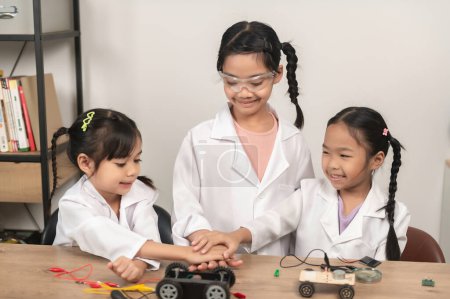 Photo for Asian littlle girl constructing and coding robot at STEM class,Fixing and repair mechanic toy car - Royalty Free Image