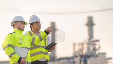Photo for Group Asian man petrochemical engineer working at oil and gas refinery plant industry factory,The people worker man engineer work control at power plant energy industry manufacturing - Royalty Free Image