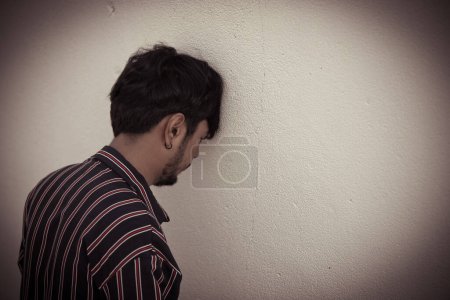 Photo for Smart thai man very sad from unrequited love,rethink,think over,vintage style,dark tone,Sad unhappy handsome man broken heart,Unpleasant pain,Thailand people - Royalty Free Image