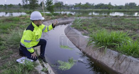 Photo for Environmental engineers inspect water quality,Bring water to the lab for testing,Check the mineral content in water and soil,Check for contaminants in water sources. - Royalty Free Image